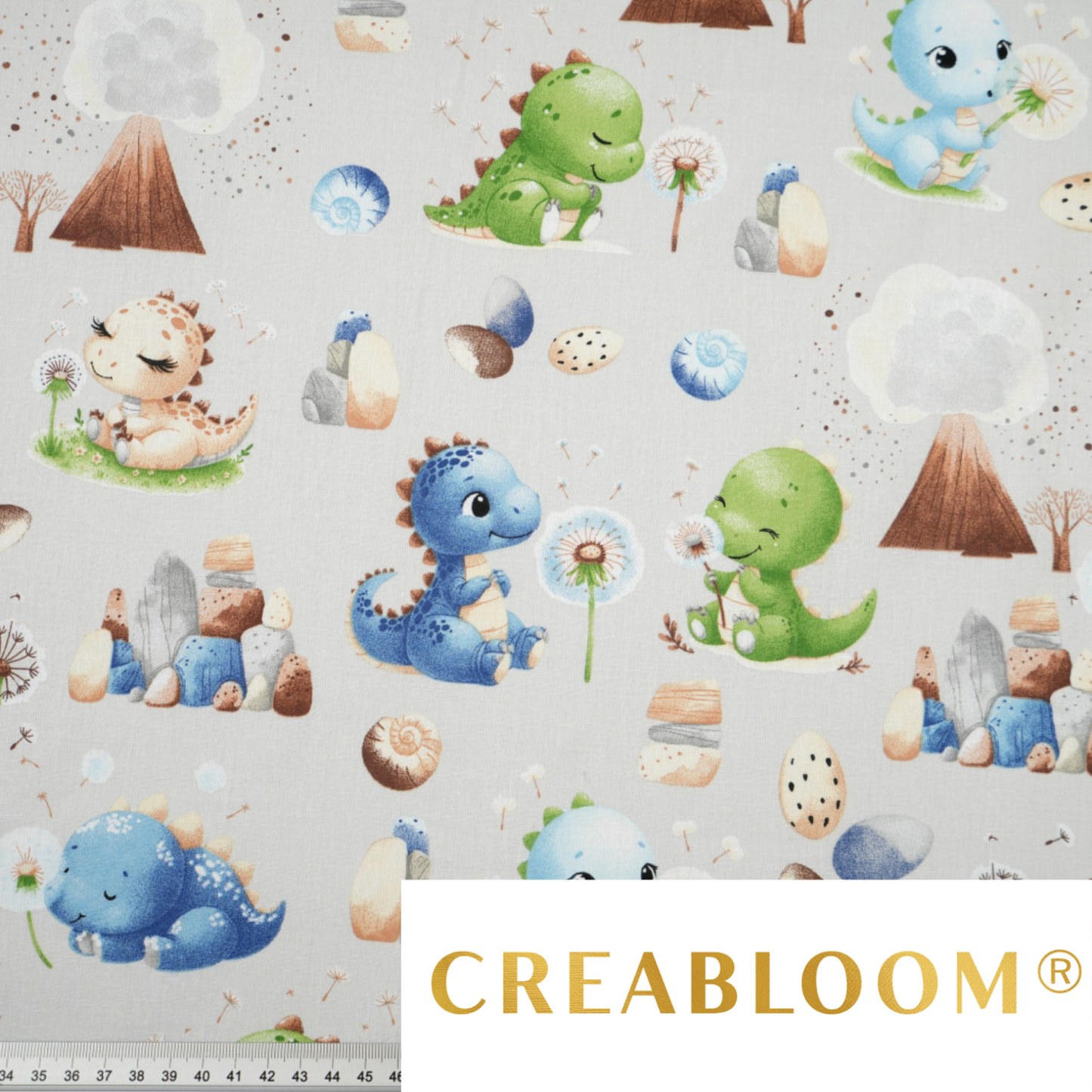 Tissu coton Motif dinosaures bleu vert avec volcan sur fond gris