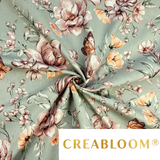 Tissu coton imprimé fleurs orange et marron sur fond olive